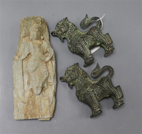 A Chinese stone fragment carved with a buddha in relief, possibly Jin Dynasty and a pair of small bronze kylin